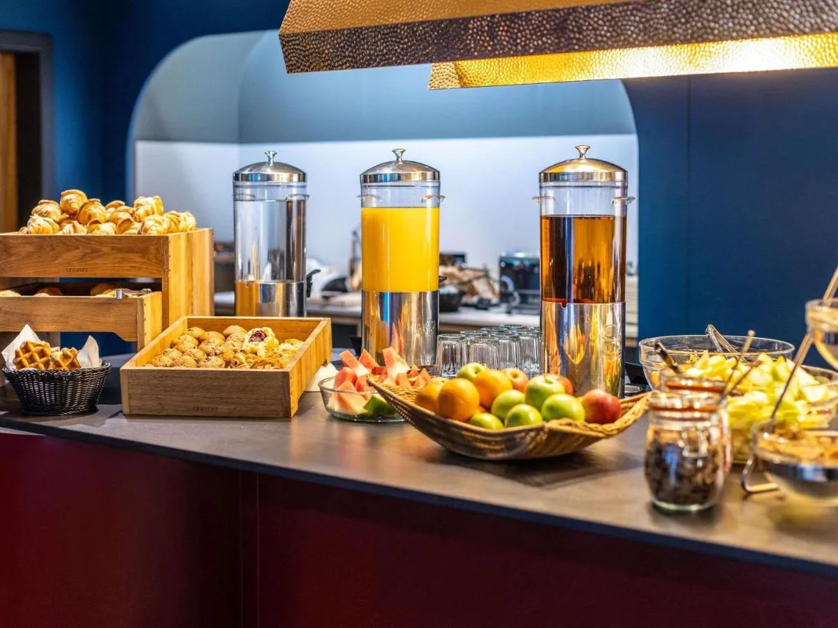 a buffet with fruit and juice on a counter at Aparthotel Adagio Edinburgh Royal Mile in Edinburgh